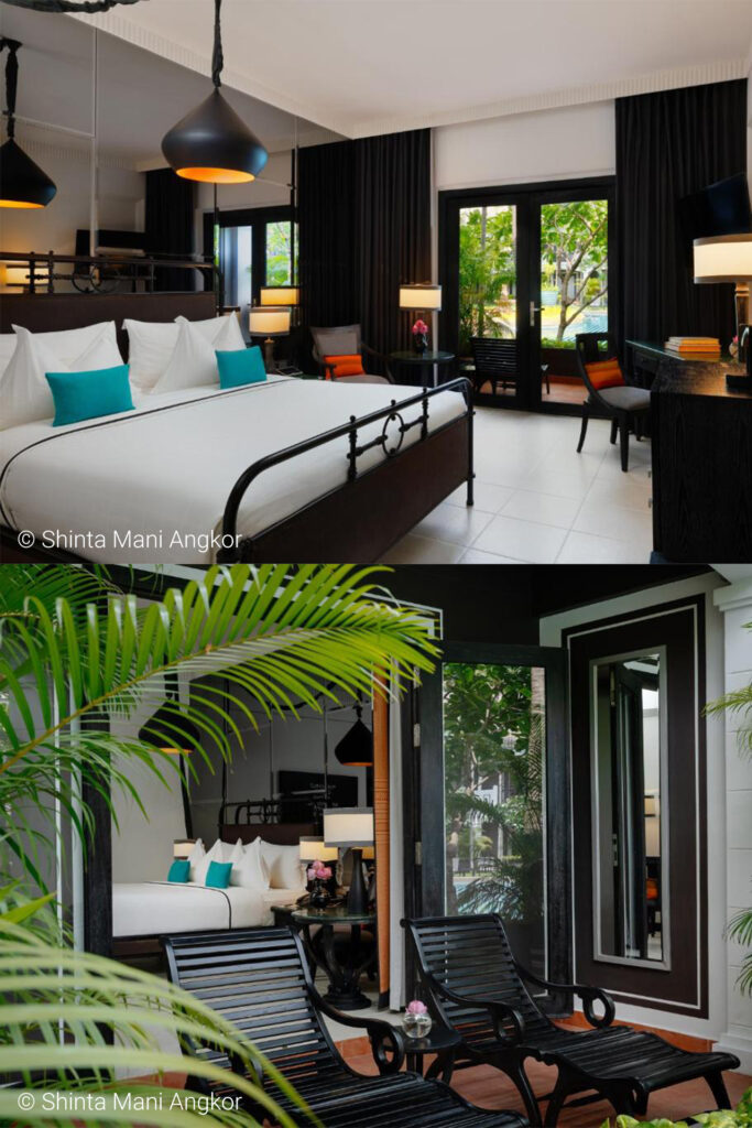 Lux hotel suite with a black metal bed, white linens and turquoise cushions, plus a seating area and pendant lights; glass doors lead to a patio.